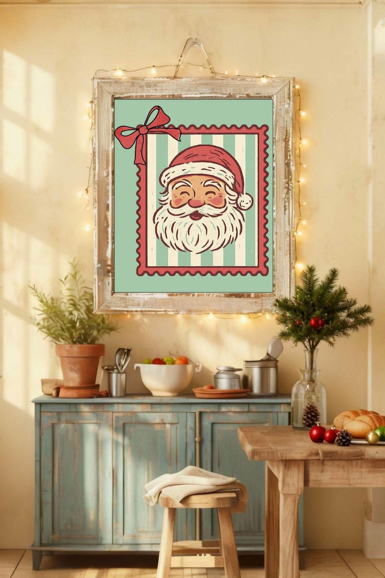 May include: A framed Christmas print featuring Santa Claus's face on a postage stamp design. The artwork has a red and white color scheme with a light blue background and is set in a rustic wooden frame. The image is part of a festive holiday decor.
