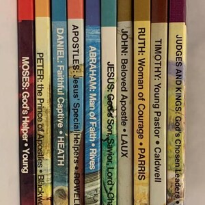 May include: A collection of ten colorful paperback books with titles and author names printed on the spines. The books are arranged vertically, with the spines facing the viewer. The books are all part of a series called "Broadman."