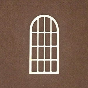 May include: A light-colored, flat, wooden cutout in the shape of an arched window frame. The design features a rounded top and a grid pattern consisting of three vertical columns and four horizontal rows, creating twelve rectangular openings.