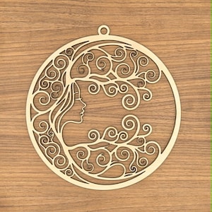 May include: A circular light-colored wooden ornament featuring a laser-cut design of a profile silhouette of a face. The hair of the figure transitions into intricate, swirling branch-like patterns that fill the circular frame, with a small loop at the top.