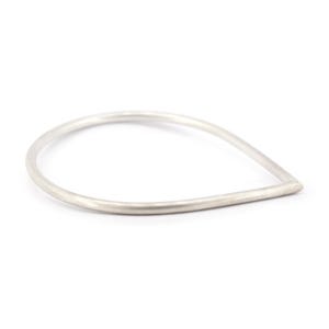 May include: A silver teardrop-shaped bangle bracelet.
