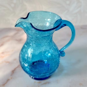 May include: A rustic wooden sign with the text "Welcome to our home" in white lettering. The sign features a distressed finish and a simple, inviting design, perfect for a front porch or entryway.