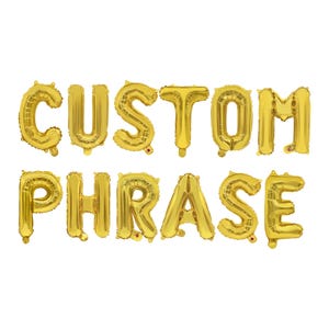 May include: Gold foil balloons spelling out "CUSTOM PHRASE" against a white background. The balloons are inflated and arranged in two rows, with the words clearly visible. Ideal for parties and celebrations.