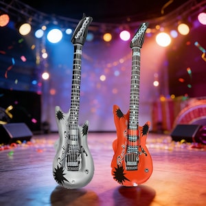 May include: Two inflatable electric guitars, one silver and one red-orange, with black starburst designs and the words "Rock n Roll" in a stylized font. The guitars have black necks and headstocks, and are set against a stage background.