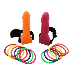 May include: Two silicone dildos, one orange and one red, each with a black strap. Colorful rings in red, yellow, green, blue, and pink are arranged in two groups.