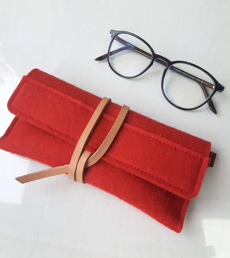 Soft mango red wool felt case for reading glasses featuring a unique leather wrap closure