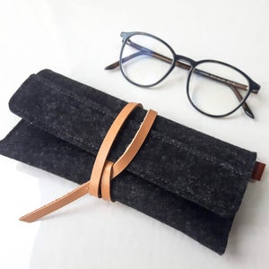 Stylish charcoal gray wool felt glasses case with a uniaque wrap around leather closure