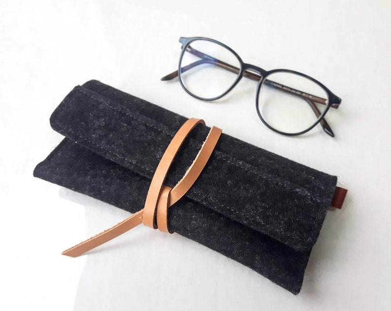 Stylish charcoal gray wool felt glasses case with a uniaque wrap around leather closure