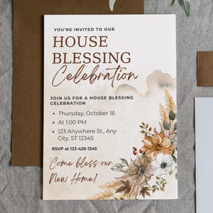 May include: A house blessing invitation with floral accents. The invitation reads "You're invited to our House Blessing Celebration." Details include the date, time, address, and RSVP information. The design features a watercolor-style background and decorative flowers.