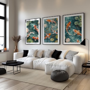 A koi pond painting displayed as a triptych wall art set above a white sofa. This elegant koi fish print adds a peaceful and sophisticated touch to a modern living room.