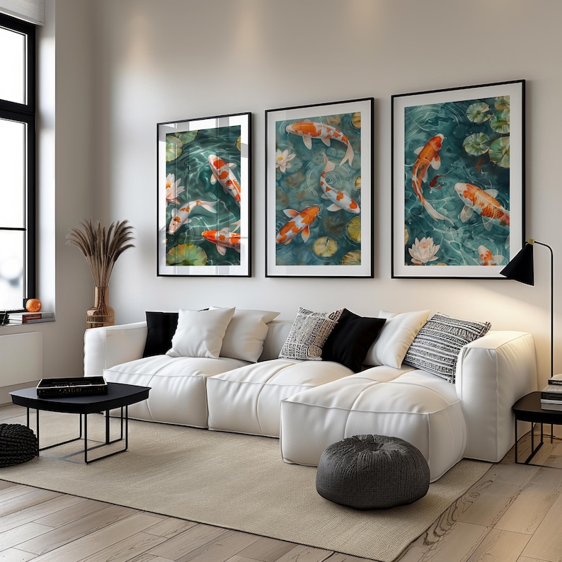 A koi pond painting displayed as a triptych wall art set above a white sofa. This elegant koi fish print adds a peaceful and sophisticated touch to a modern living room.