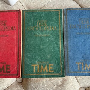 May include: Three hardcover books with the title "The Oxford Desk Encyclopedia" on the front cover. The books are red, green, and blue. Each book has the word "TIME" printed on the bottom of the cover.