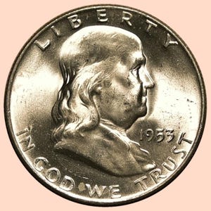 May include: A silver coin featuring a profile of a man, with the words "LIBERTY" and "IN GOD WE TRUST" inscribed around the edge. The year "1953A" is also visible. The coin has a detailed, aged appearance.