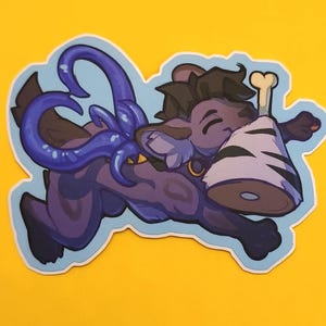 May include: A sticker featuring a cartoon creature with purple fur, a blue tentacle, and a bone. The creature is running and holding a wrapped object. The sticker has a light blue outline and is set against a yellow background.