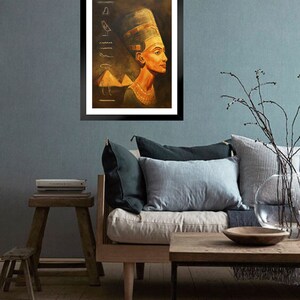 May include: A framed painting of an Egyptian queen wearing a golden headdress and a necklace. The background is a dark brown with hieroglyphics and a pyramid.