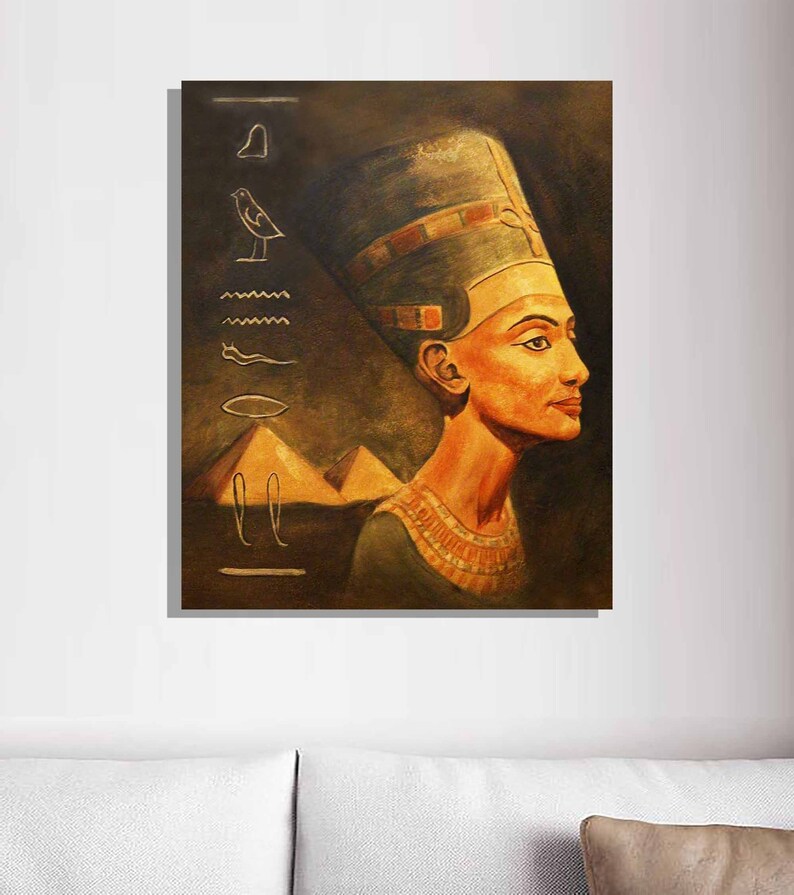 May include: A painting of an Egyptian queen wearing a golden headdress and a necklace. The background is a dark brown with hieroglyphics and pyramids.