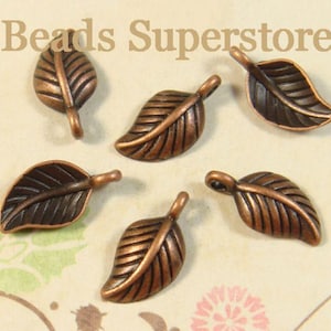 May include: Five copper-colored metal leaf charms with a dark patina finish and a small loop at the top for attachment. The charms feature embossed vein details on the surface. The text Beads Superstore is visible at the top of the image.