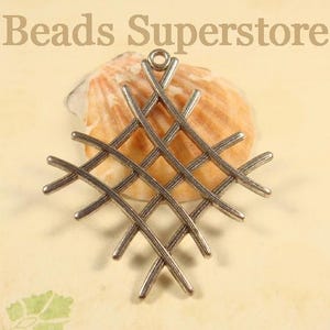 May include: A silver-toned metal pendant featuring a diamond-shaped grid pattern with intersecting lines and a small circular loop at the top for attachment. The text Beads Superstore is visible at the top of the image above the pendant.
