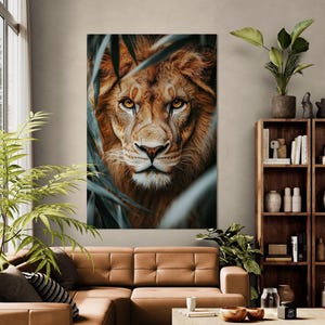 May include: A close-up portrait of a lion's face, with its eyes looking directly at the viewer. The lion is surrounded by green leaves, creating a sense of mystery and intrigue.