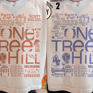 May include: White t-shirt featuring the text "ONE TREE HILL" in large letters. The shirt includes various graphics and text elements related to the show, such as character names, locations, and symbols. The design is in shades of orange and blue.