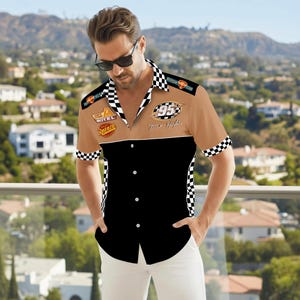 May include: A short-sleeved button-down shirt with a racing theme. The shirt features a tan upper section with racing patches and the number "95". The lower section is black, and the collar and cuffs have a checkered pattern.