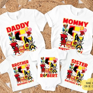 May include: White t-shirts with colorful graphics featuring comic book characters and the number 5. The shirts are labeled "Daddy," "Mommy," "Brother," and "Sister," with a onesie for "Robert." The text "Name & Age Can Be Changed" is also visible.