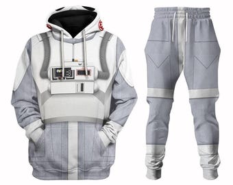 May include: A white and light gray hooded sweatshirt and matching sweatpants set featuring a printed graphic of a pilot uniform. The hoodie includes a chest control panel design, gray tubing details, and a red circular emblem on the hood.