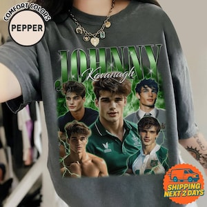 May include: Dark gray t-shirt featuring a collage of images of a man, with the name "JOHNNY Kavanagh" in green. The shirt has a vintage aesthetic, with a distressed look. The shirt is from the brand "Comfort Colors".
