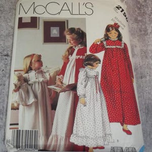 May include: A McCall's 2190 sewing pattern envelope featuring illustrations of children wearing long-sleeved nightgowns with ruffled collars and cuffs. The designs include a solid white gown and two polka-dot gowns in red and white.