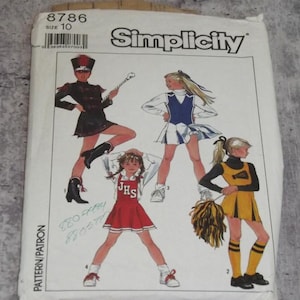 May include: A Simplicity sewing pattern envelope, number 8786, size 10, featuring illustrations of four cheerleading outfits. The designs include a black uniform with a baton, a blue and white skirt set, a red JHS uniform, and a yellow and black outfit with pom-poms.