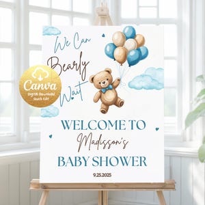 May include: A baby shower sign with a teddy bear and balloons. The sign says "We Can Bearly Wait" and "Welcome to Madisson's Baby Shower" with the date 9.25.2025. The design includes blue and beige balloons and clouds.