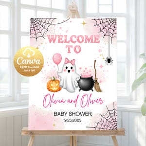 Puede incluir: Un letrero de baby shower rosa y blanco con temática de Halloween. El letrero dice "Bienvenida a" en letras rosas con burbujas. También se muestra un fantasma de dibujos animados, una calabaza, un caldero y una telaraña. Los nombres Olivia y Oliver están escritos en cursiva.