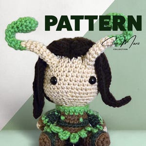 May include: A crocheted doll with a beige head, black eyes, and dark brown hair. The doll has green and beige antennae and is wearing a green and brown outfit. The word "PATTERN" is displayed in large, dark green letters.