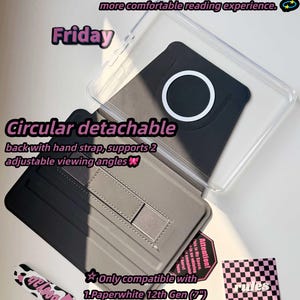 May include: A black and gray Kindle Paperwhite case with a clear cover. The case features a circular detachable back with a hand strap and supports two adjustable viewing angles. Text on the case reads "Friday" and "Circular detachable".