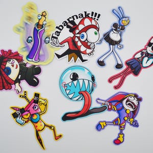 May include: A selection of vibrant cartoon stickers depicting eccentric characters. One sticker displays the text "Tabarnak!!!". The stickers feature diverse designs, including a character with a large eye, a bunny in a maid outfit, and a character with a gun.