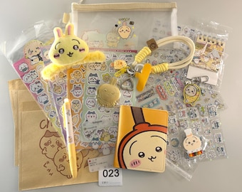 May include: A collection of stationery and accessories featuring a cartoon bunny character. Items include stickers, a pen, a wallet, a keychain, a plush, and a clear pouch. The color palette is primarily yellow, white, and brown.