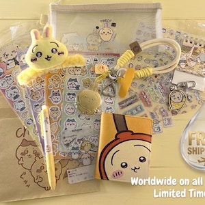 May include: A collection of stationery items featuring a yellow plush rabbit clip, a yellow pen, a yellow and brown character-themed notebook, various sticker sheets with cartoon characters, a lanyard with a metal charm, and a small notepad.