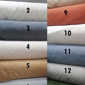 May include: Image of a Turkish Soft Boucle MD Tower. The image displays a variety of fabric swatches in various colors, including light gray, white, navy blue, tan, and rust. The swatches are numbered 1 through 13.