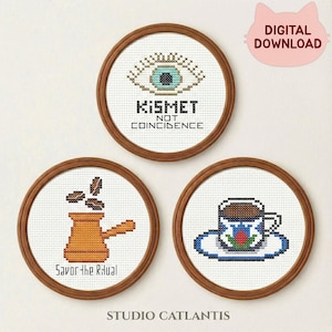May include: Three circular cross-stitch designs in wooden hoops. One shows an eye with the text "Kismet Not Coincidence." Another depicts a coffee pot with the text "Savor the Ritual." The third shows a coffee cup. A pink cat graphic says "Digital Download."