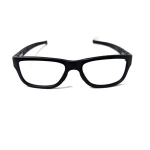 May include: Black rectangular eyeglasses with clear lenses. The frames are a matte black and have a classic design. The arms of the glasses are thin and curve slightly. The glasses are set against a white background.