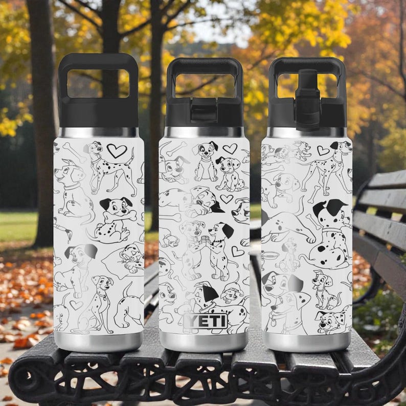 May include: Three stainless steel water bottles with black lids and handles. The bottles are white with a black and white Dalmatian dog pattern. The bottles are sitting on a black bench in a park.