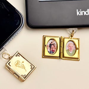 May include: Gold-colored locket with a floral design and a rectangular shape. The locket is closed, with a small loop for attaching to a keychain. Another open gold locket displays two oval-shaped photos of a family and a man.