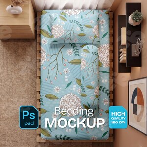 May include: A bedding mockup featuring a light blue comforter and pillow set with a floral pattern. The design includes white and beige flowers, green leaves, and brown stems. The text "Bedding MOCKUP" is displayed.