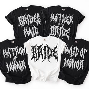 May include: Five t-shirts with gothic-style text. Four black shirts read "Bridesmaid", "Mother of the Bride", "Matron of Honour", and "Maid of Honour". The fifth shirt is white and says "Bride".