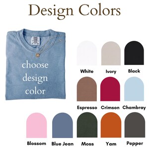 May include: A light blue t-shirt with a gold necklace, with the words "choose design color" in white. Color swatches include white, ivory, black, espresso, crimson, chambray, blossom, blue jean, moss, yam, and pepper.