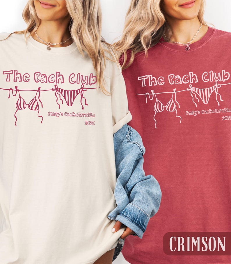 May include: Two t-shirts, one cream and one crimson, with the text "The Bach Club" and a bikini graphic. Below the graphic is "Emily's Bachelorette 2026". The crimson shirt has the word "CRIMSON" at the bottom.