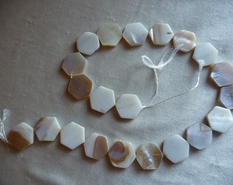 Beads, Mother of Pearl, 18mm Flat Hexagon, Natural Bleached/White. Sold per 15 inch strand. Total of 21 beads on strand.