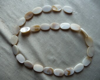 Beads, Mother of Pearl, 15x10mm Flat Oval, White/Natural Bleached. Sold per 15-inch strand. There are 26 beads on the strand.