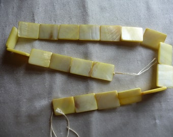 Beads, Mother of Pearl, 20x15mm Flat Rectangle, Shades of Yellow. Sold per 16-inch strand. There are 20 beads on the strand.