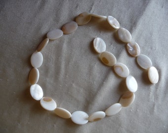 Beads, Mother of Pearl, 20x15mm Flat Oval, White/Natural Bleached. Sold per 16-inch strand. There are 23 beads on the strand.